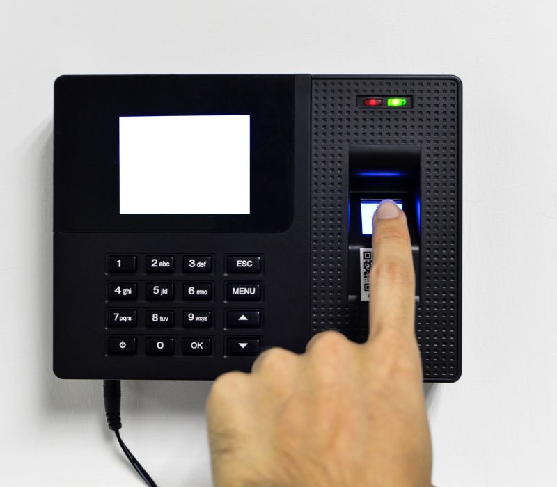 someone applying attendance on attendance machine