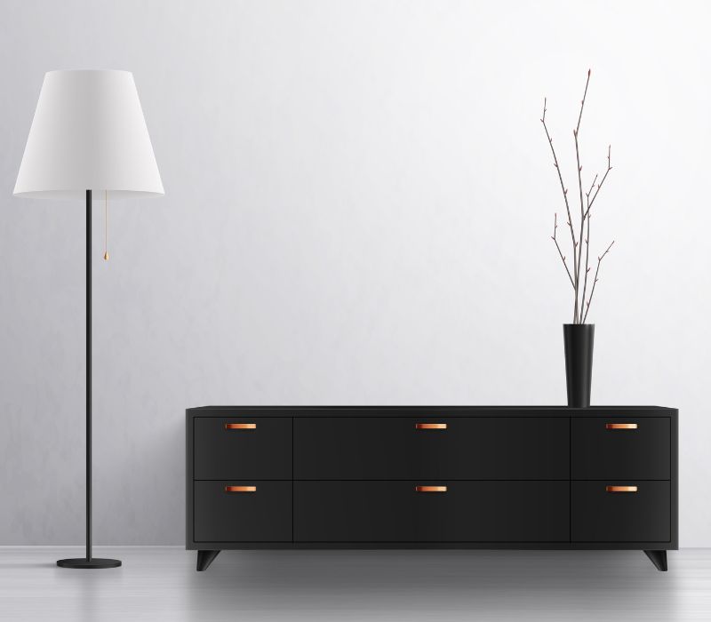 dark colored tv stand with lamp besides it
